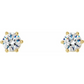 Gold earrings with clear gemstones on a white background