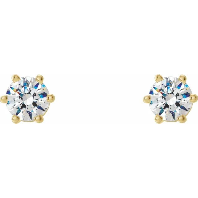Gold earrings with clear gemstones on a white background