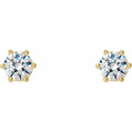 Gold earrings with clear gemstones on a white background