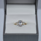 Diamond ring in a gray jewelry box on a light gray background