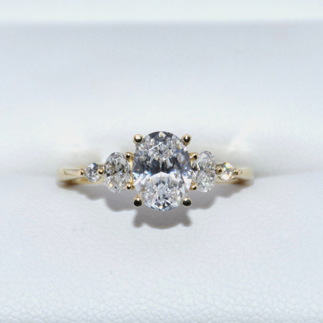 Gold ring with three diamonds on a white background