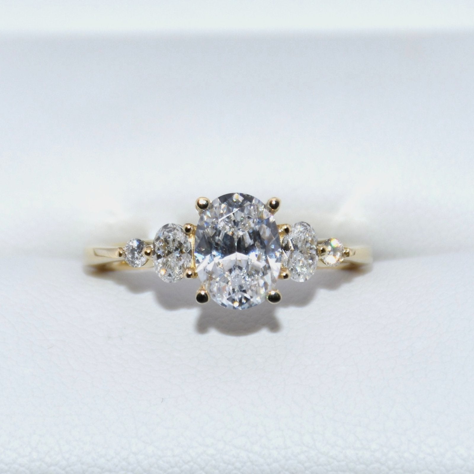 Gold ring with three diamonds on a white background
