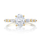 Gold and silver ring with a large central diamond and smaller diamonds on the sides on a white background