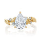 Gold ring with a pear-shaped diamond on a white background