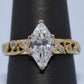 Gold ring with a large diamond on a black stand
