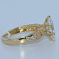 Gold ring with diamond accents on a light gray background