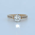 Gold ring with a diamond on a light blue background