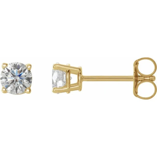 Gold stud earrings with clear gemstones on a white background
