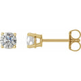 Gold stud earrings with clear gemstones on a white background