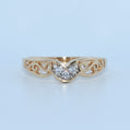 Gold ring with diamond design on a light blue background