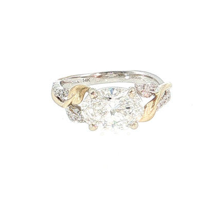 Gold and silver ring with a large central diamond and smaller diamonds on the band against a white background 14K Gold |Y/WG East-West 2.04 Lab Oval w/ .12ct Round Diamond Accents Engagement Ring
