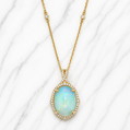 Gold necklace with an opal pendant on a white marble background 14K Gold | Yellow Gold Ethiopian Opal and Natural Diamond Pendant with Necklace Set