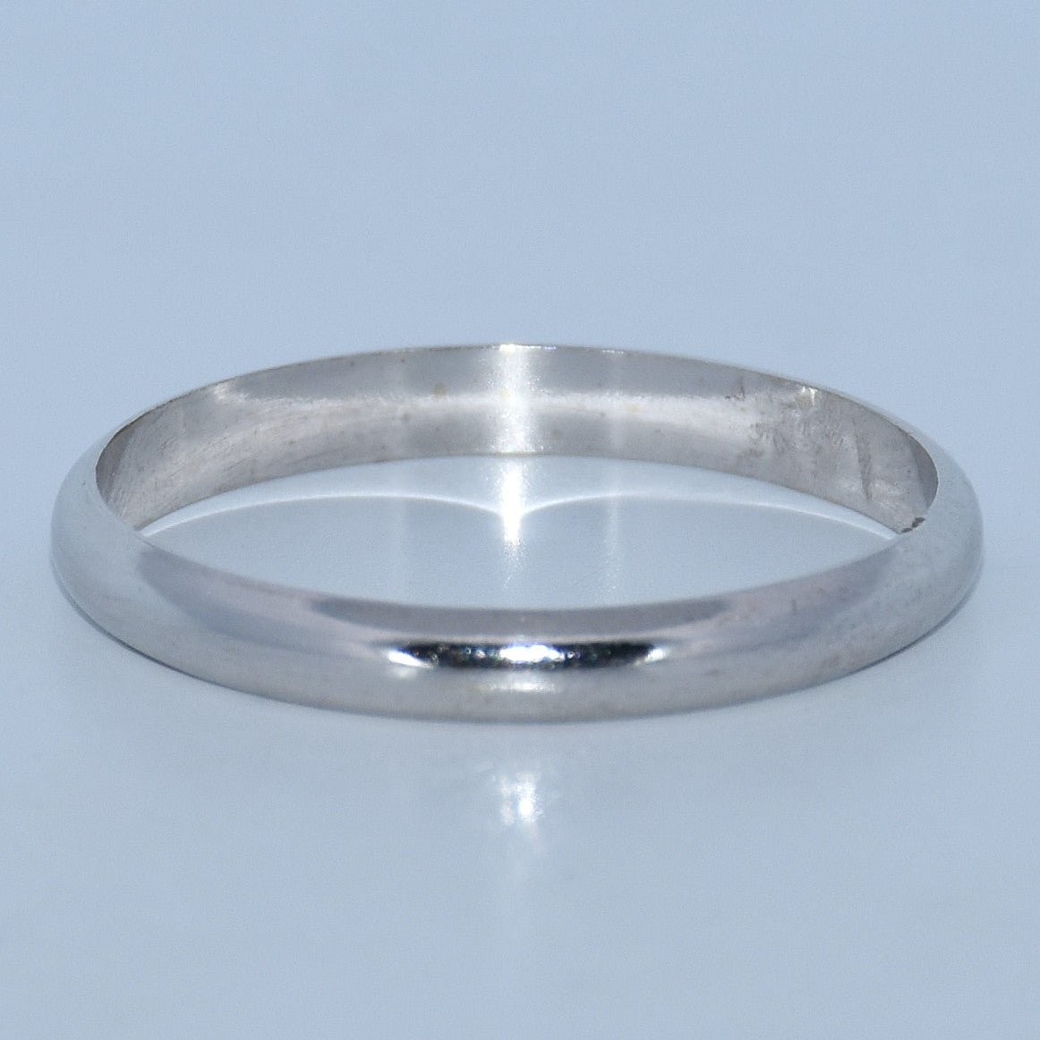 Silver ring on a light blue background