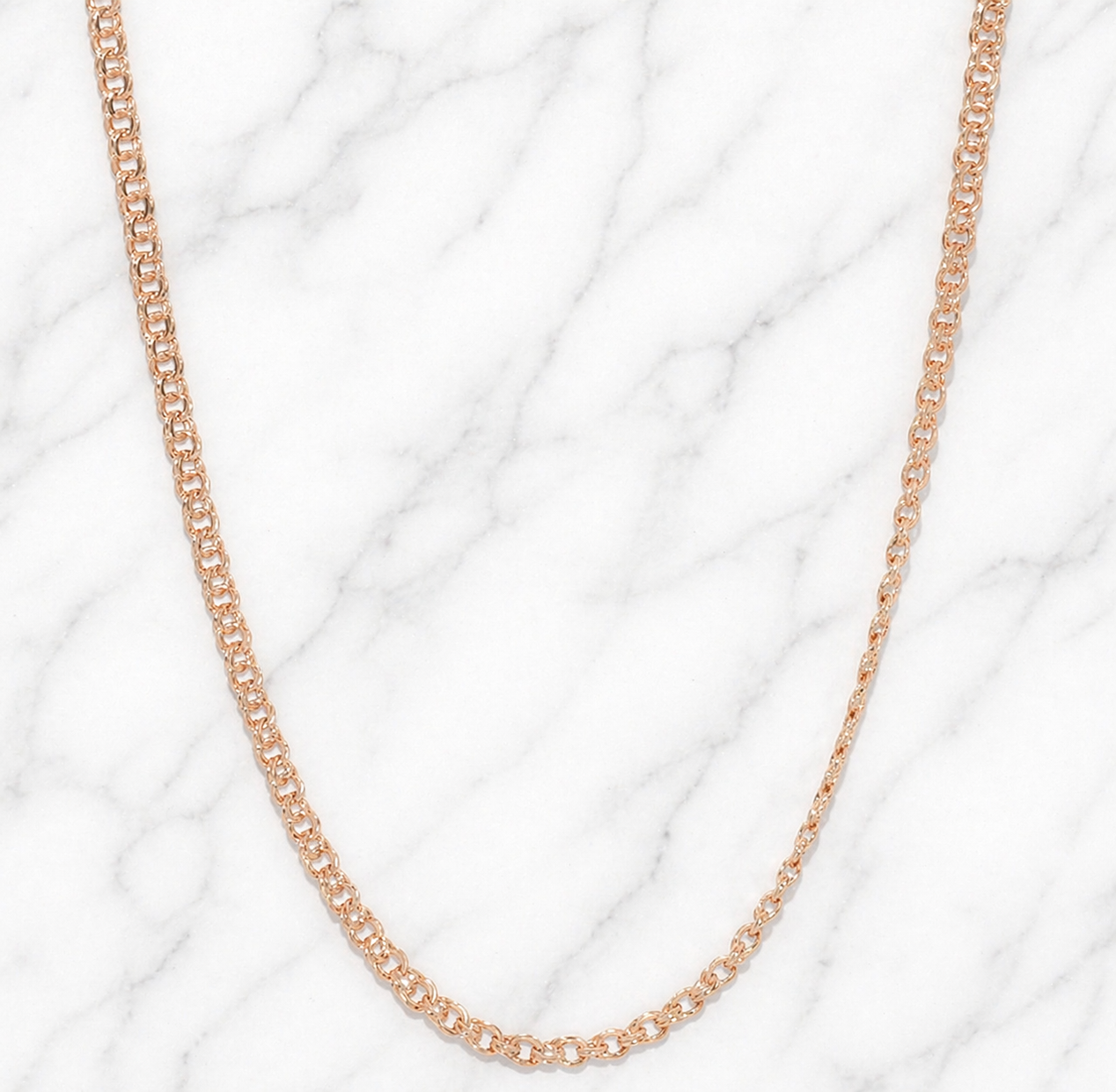 19.2K Portuguese Gold | 22" 2.5mm Freeze Chain Rose gold chain necklace on a white marble background