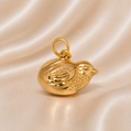 Gold bird-shaped pendant on a beige satin background 19.2K Portuguese Gold | Baby Chicken Charm
