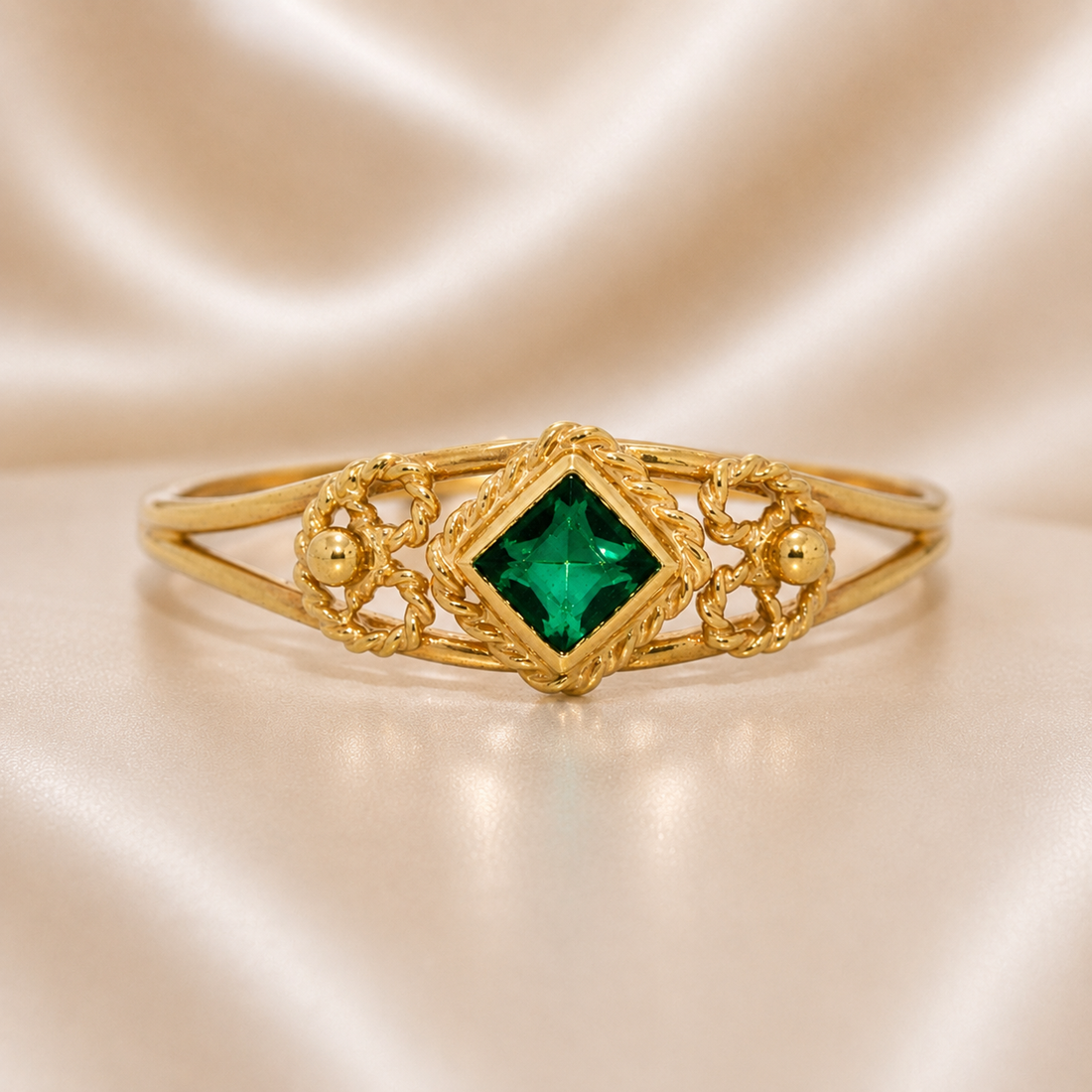 Gold bracelet with a green gemstone on a beige satin background 19.2K Portuguese Gold | Baby Filigree Emerald Ring