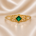 Gold bracelet with a green gemstone on a beige satin background 19.2K Portuguese Gold | Baby Filigree Emerald Ring