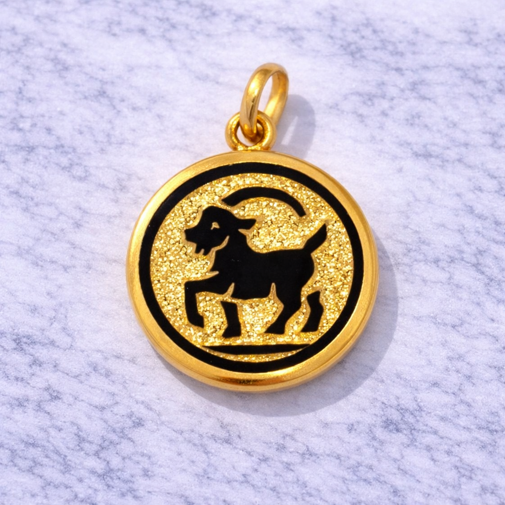 19.2K Portuguese Gold Capricorn pendant with black goat symbol on a marble surface