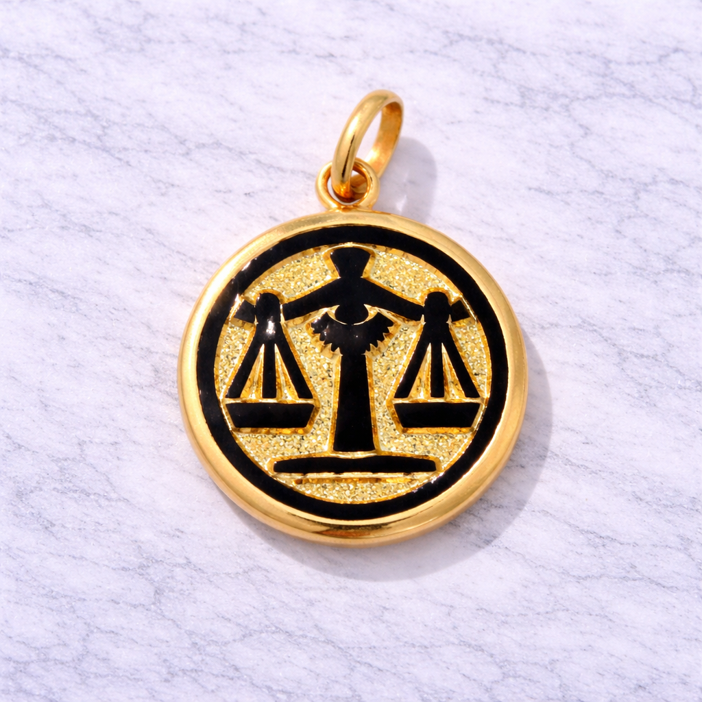 19.2K Portuguese Gold and black Libra zodiac pendant on a light gray background