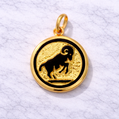 19.2K Portuguese Gold pendant with black Aries ram symbol on a white textured background