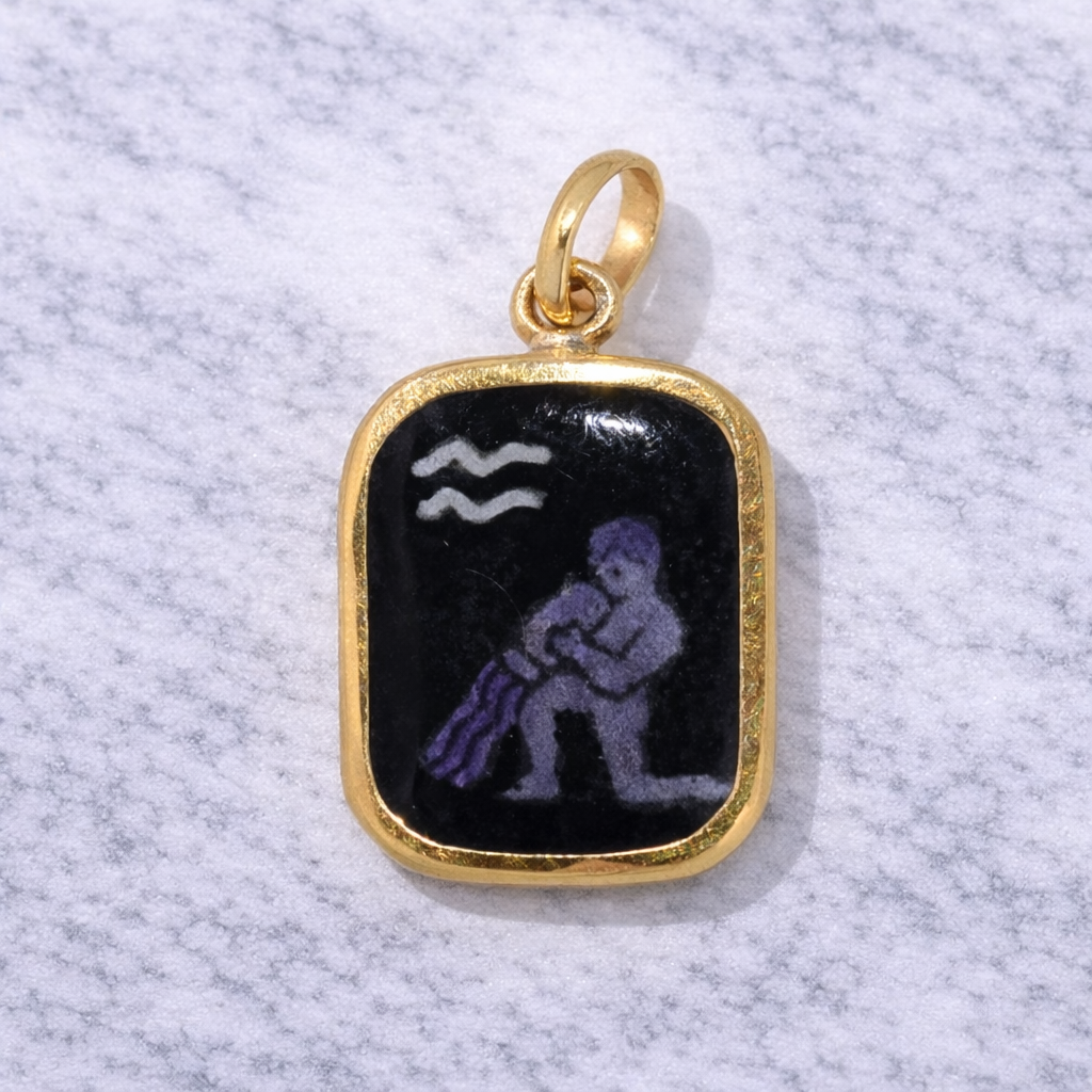 19.2K Portuguese Gold pendant with black and purple Aquarius design on a textured gray background