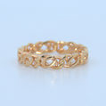 Gold chain-style ring on a light blue background