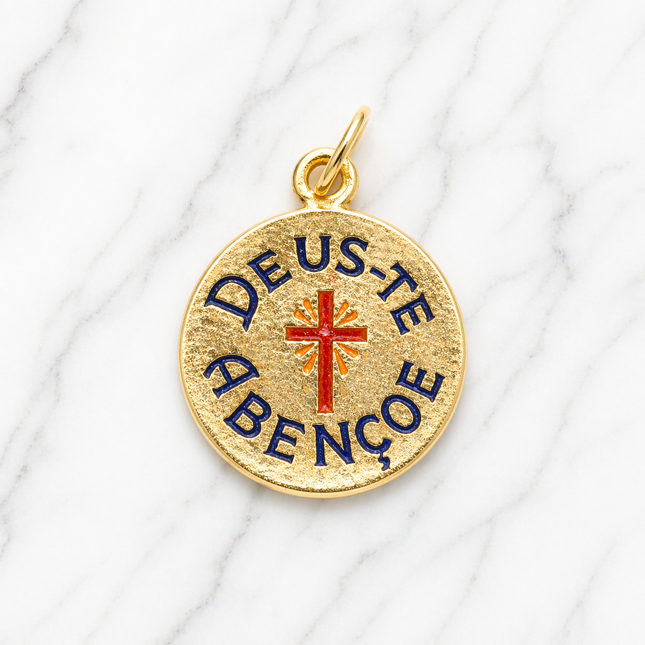 Gold pendant with 'Deus Te Abenção' text and red cross on a white fabric background 19.2K Portuguese Gold | Deus te Abencoe Charm
