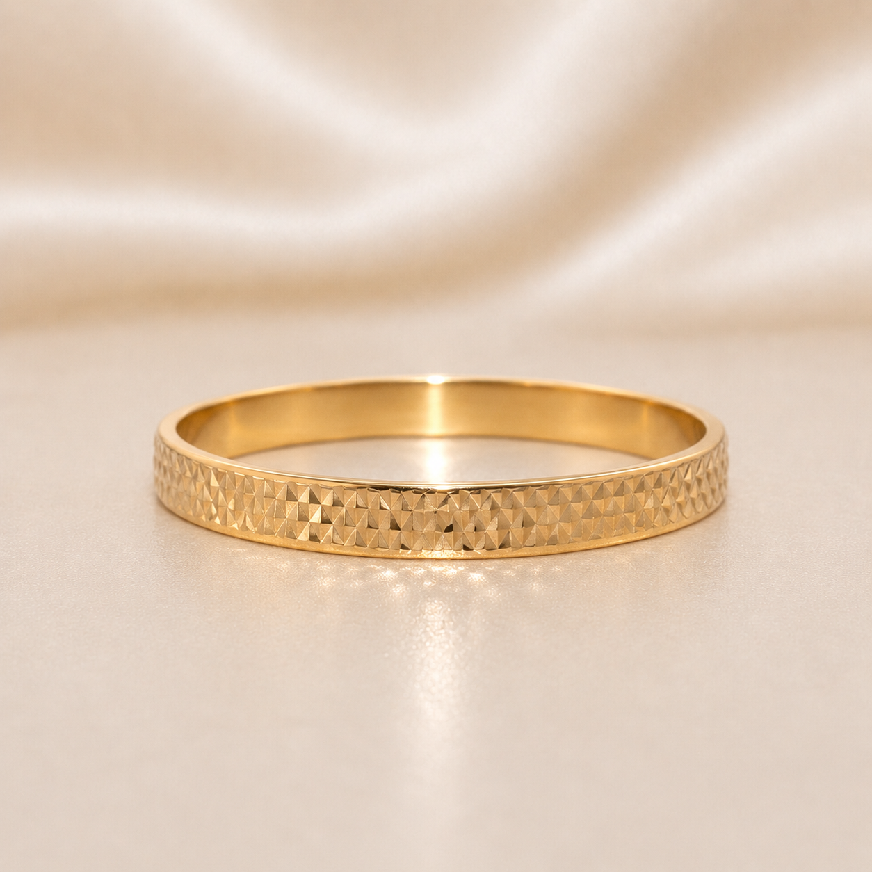 Gold bracelet with textured design on a beige background 19.2K Portuguese Gold | Diamond Cut Plain