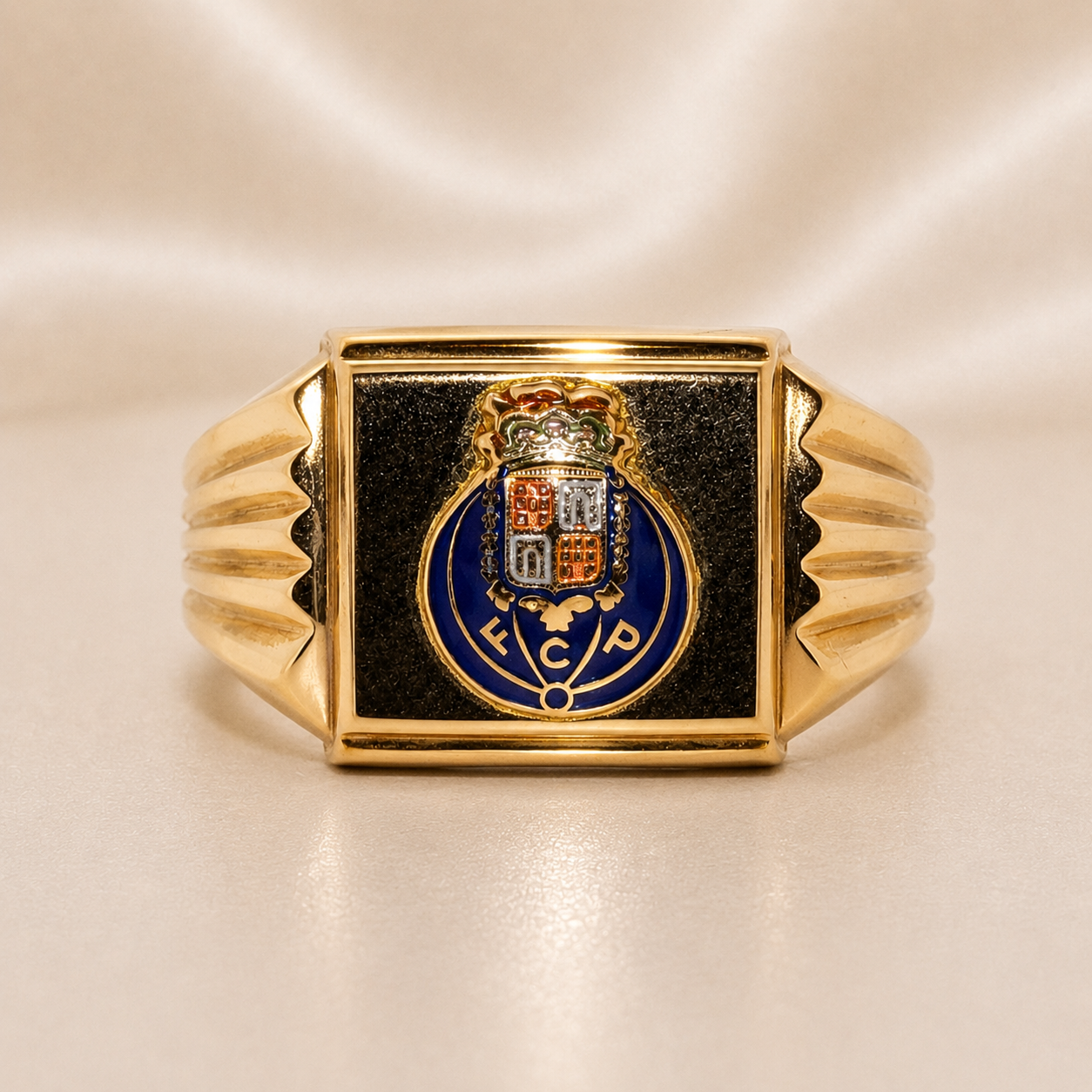 Gold ring with a black square face featuring a crest on a beige  19.2K Portuguese Gold | FCP Soccer Rings Square FC Porto background