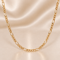 Gold chain necklace on a beige satin background 19.2K Portuguese Gold | Figaro Chain 18"