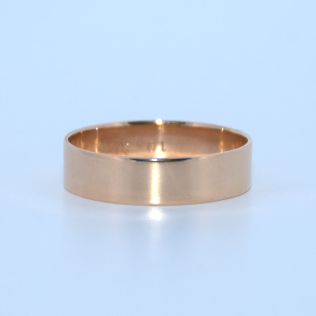 Gold ring on a light blue background