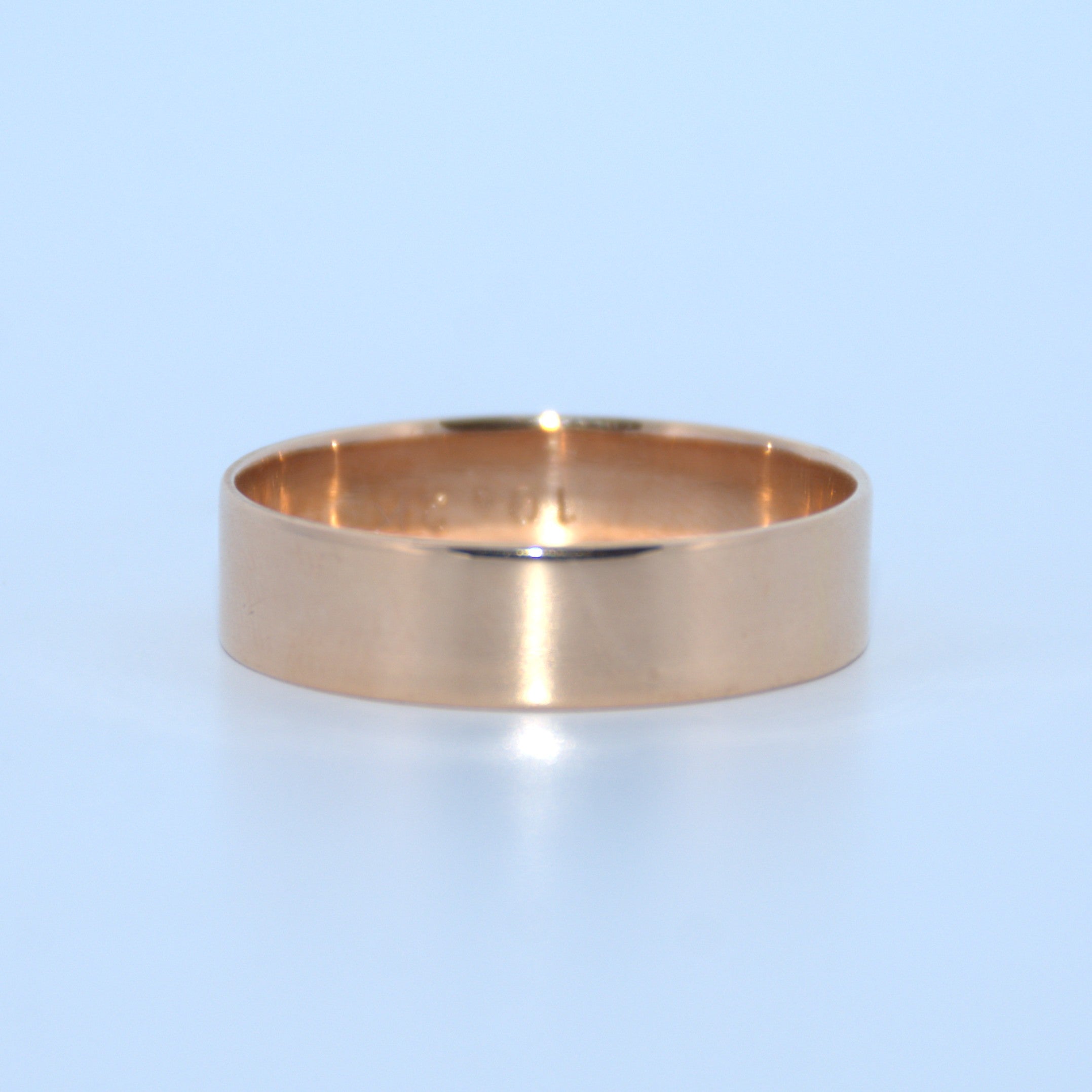 Gold ring on a light blue background