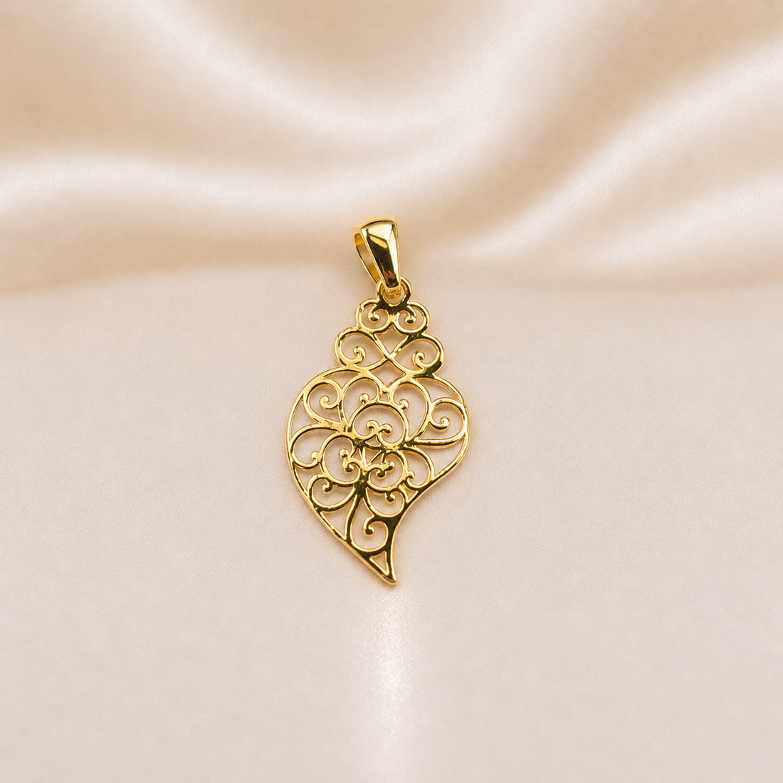 Gold pendant with intricate design on a satin background 19.2K Portuguese Gold | Heart Of Vienna Lightweight Cutout Pendant