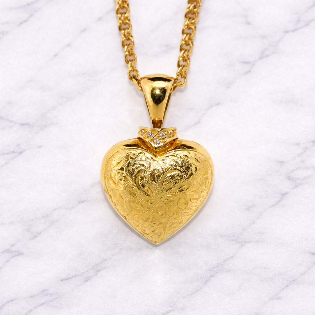 19.2k Portuguese Gold heart-shaped pendant necklace on a white textured background