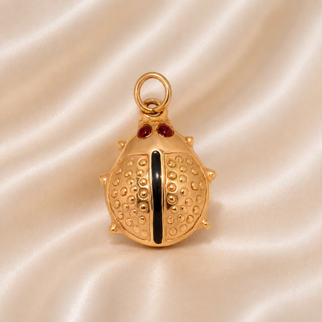Gold pendant with red stones on a beige satin background 19.2K Portuguese Gold | Ladybug Charm 