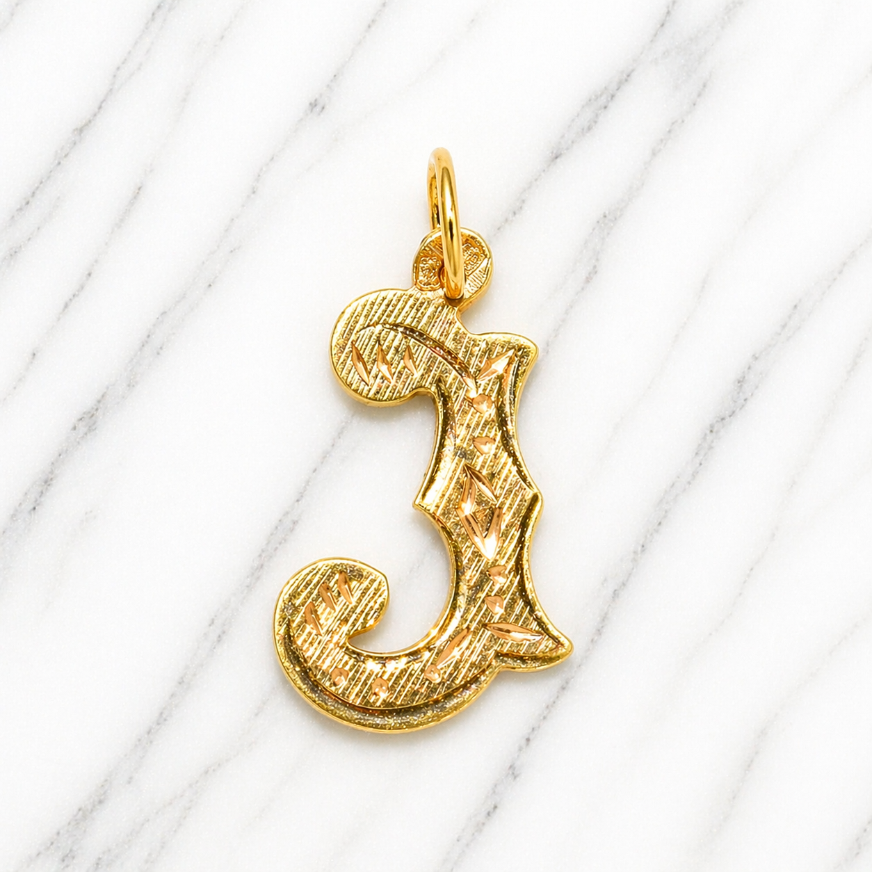 Gold letter 'J' pendant on a white marble background 19.2K Portuguese Gold | Large Initial Charm Letter Pendants Initial Letter 