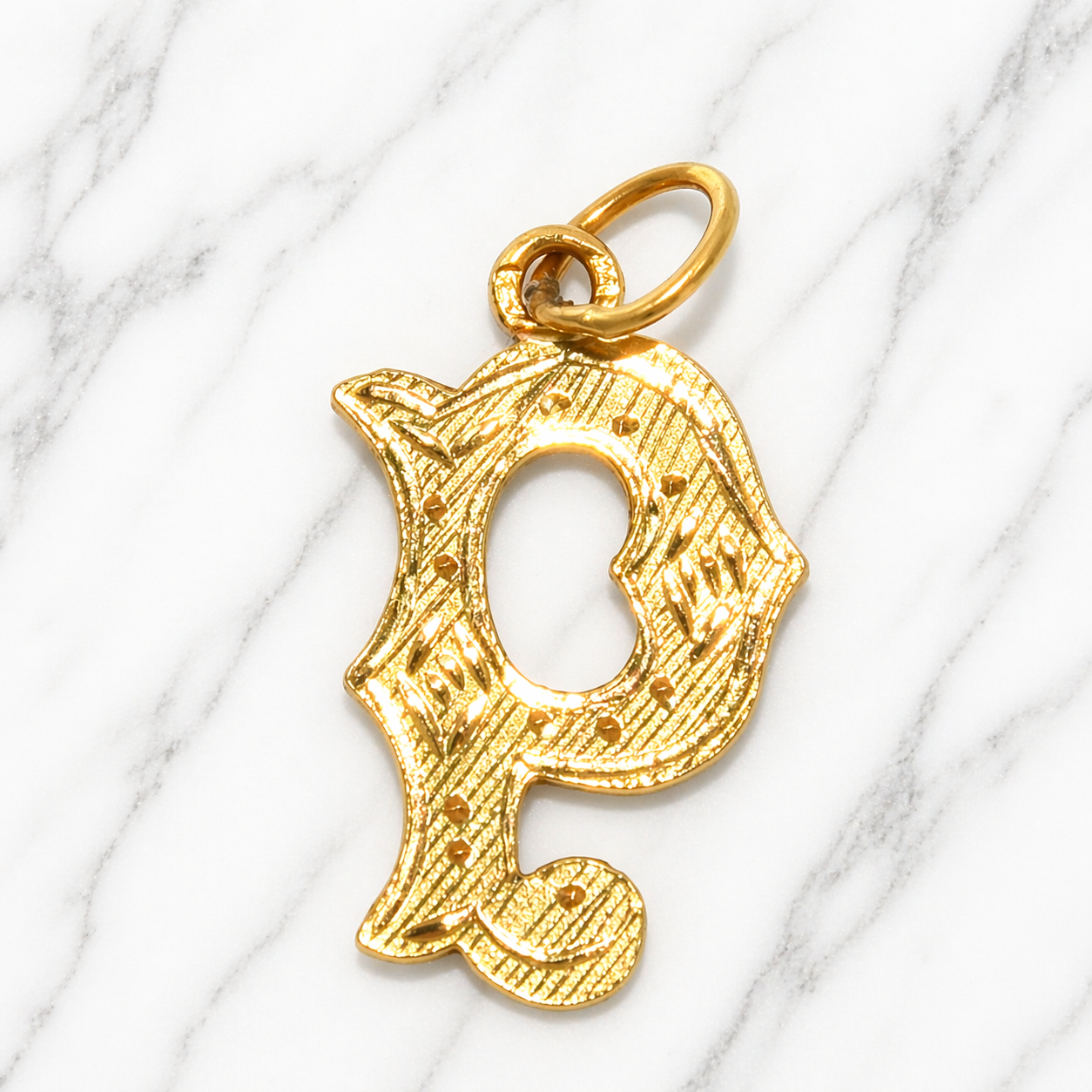 Gold letter 'P' pendant on a marble background 19.2K Portuguese Gold | Large Initial Charm Letter Pendants