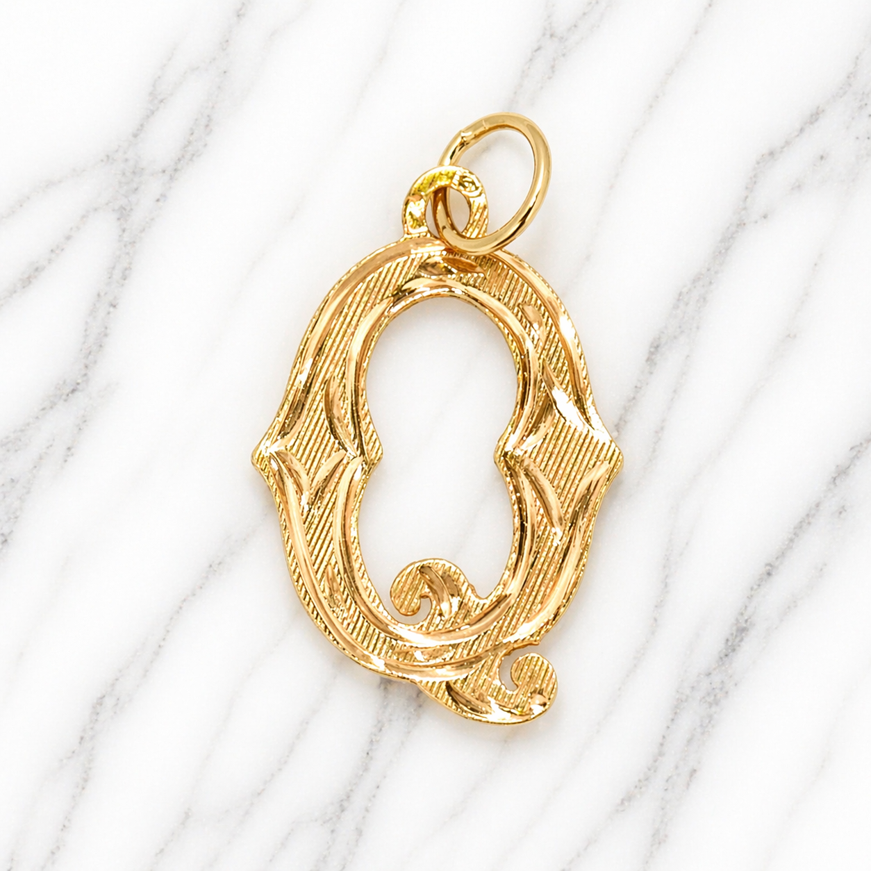 Gold letter 'Q' pendant on a marble background 19.2K Portuguese Gold | Large Initial Charm Letter Pendants
