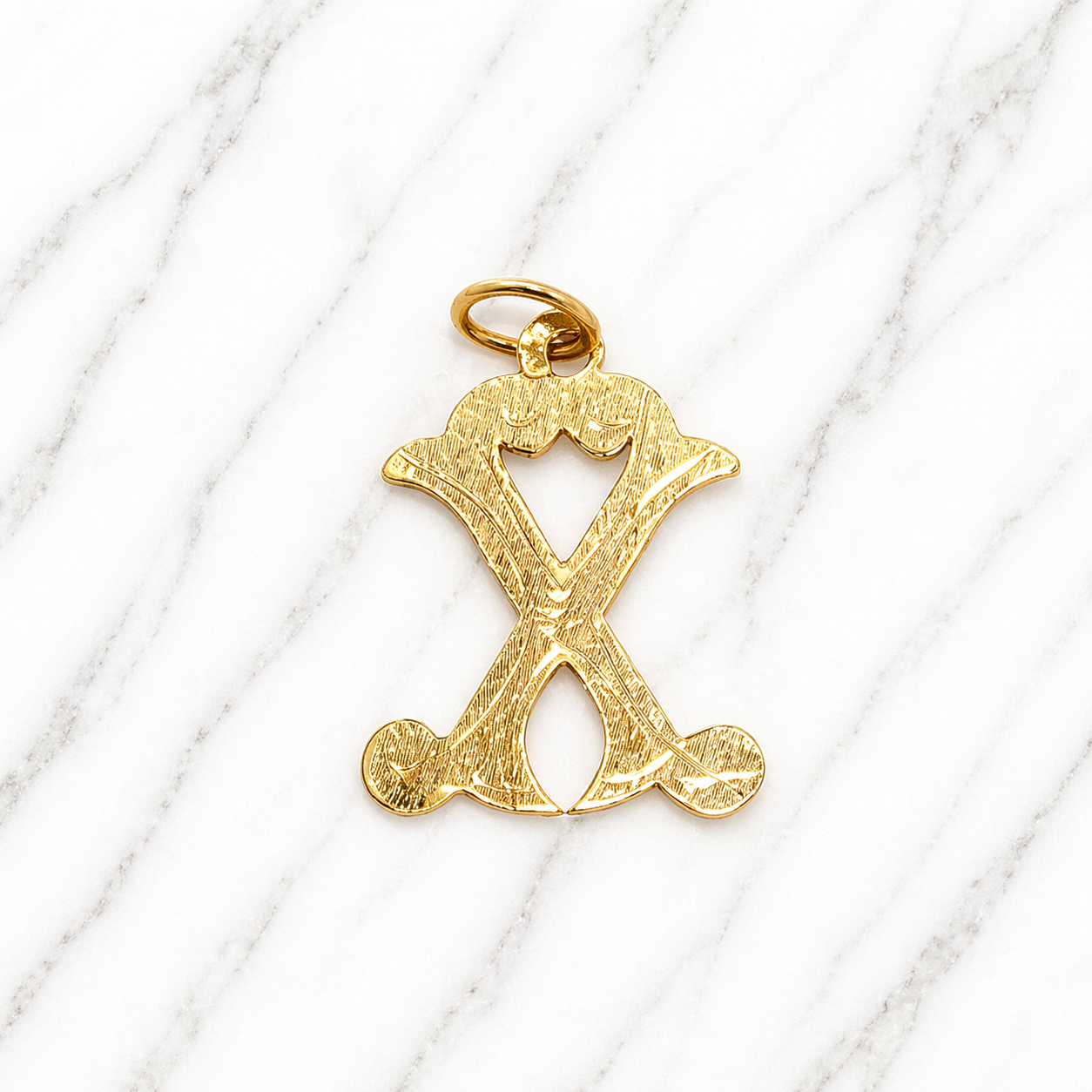 Gold letter 'X' pendant on a white marble surface 19.2K Portuguese Gold | Large Initial Charm Letter Pendants 