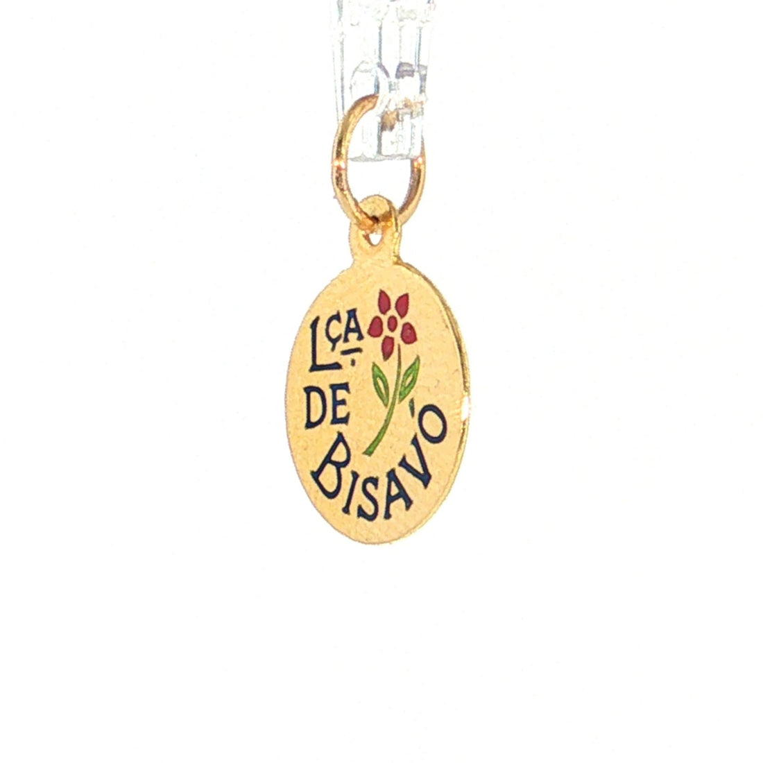 A gold oval pendant charm featuring the Spanish phrase 'LA CA DE BISAVO' in black lettering, a small red flower, and green leaves, suspended from a clear plastic string against a white background. 19.2K Portuguese Gold | Lca de Bisavó (Great Grandmother) Charms 