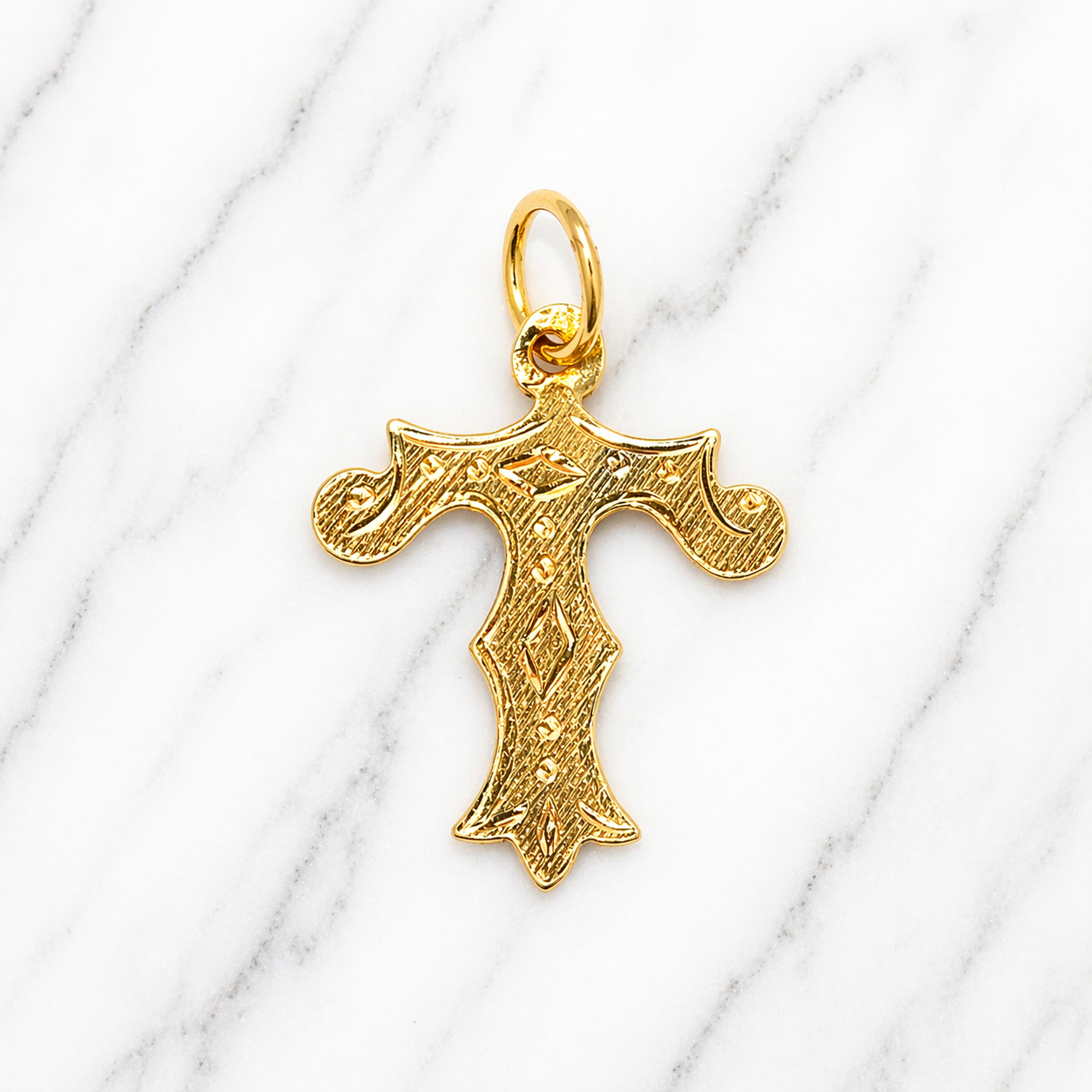 Gold cross pendant on a white marble surface 19.2K Portuguese Gold | Medium Initial Charms Letter Initial T