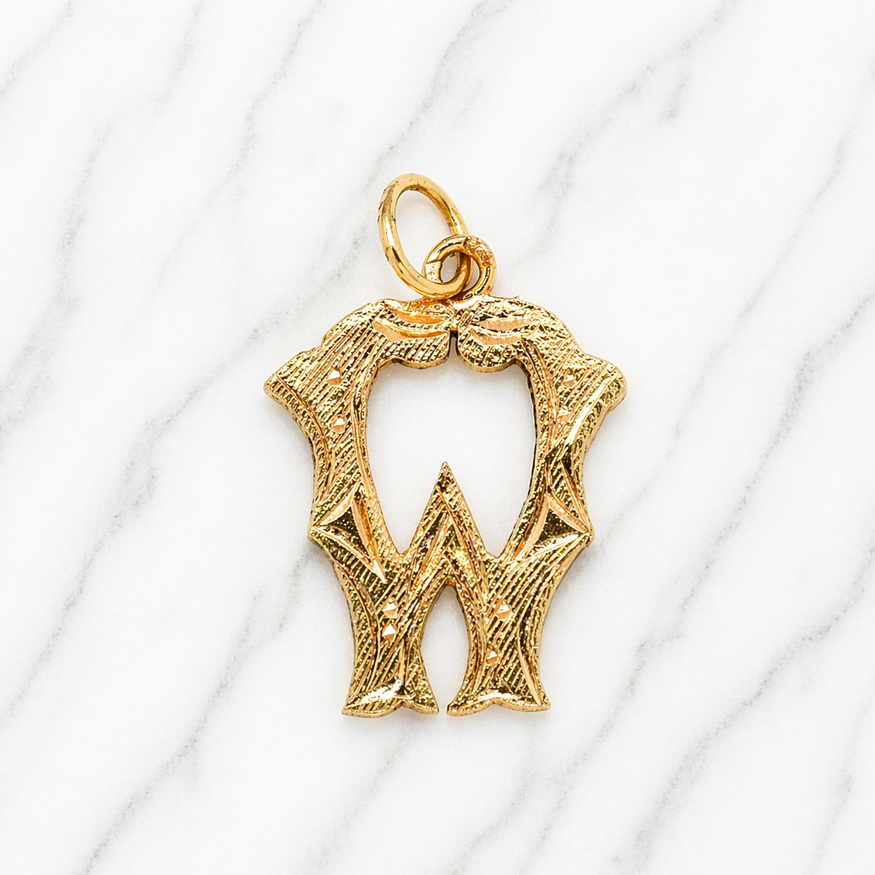 Gold letter 'W' pendant on a white background 19.2K Portuguese Gold | Medium Initial Charms Initial