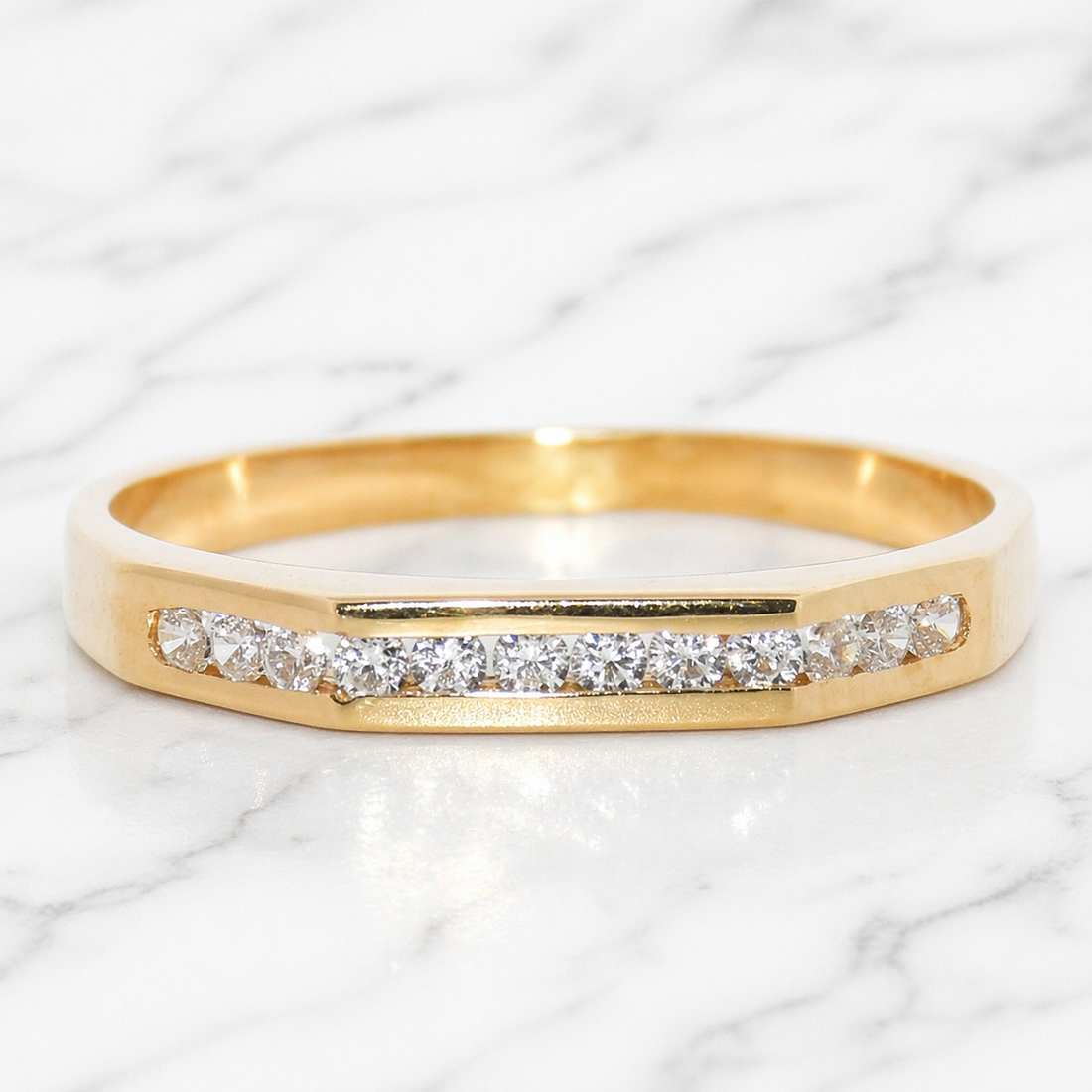 19.2K Portuguese Gold ring with cubic zirconiass on a marble background size 7.5