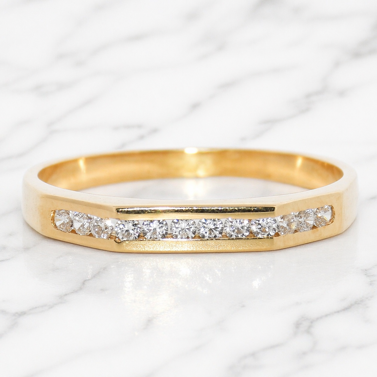 19.2K Portuguese Gold ring with cubic zirconiass on a marble background size 7.5