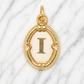 Gold pendant with letter 'I' on a marble background 19.2K Portuguese Gold | Oval Initial Charms
