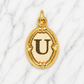 Gold pendant with letter 'U' on a marble background 19.2K Portuguese Gold | Oval Initial Charms