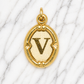 Gold pendant with letter 'V' on a marble background 19.2K Portuguese Gold | Oval Initial Charms