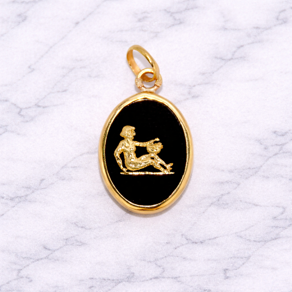 19.2k Portuguese Gold Aquarius Zodiac Sign pendant with black stone featuring a engraved design on a marble background