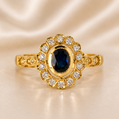 Gold ring with a blue gemstone and diamond accents on a beige satin background 19.2K Portuguese Gold | Oval Sapphire 1.04ct 5x7 Natural Diamond Ring