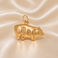 Gold pig-shaped pendant on a beige satin background 19.2K Portuguese Gold | Pig Charm